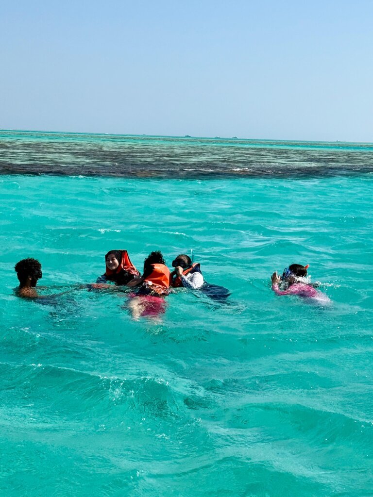 Snorkeling above colorful coral reefs in the Red Sea near Hurghada.